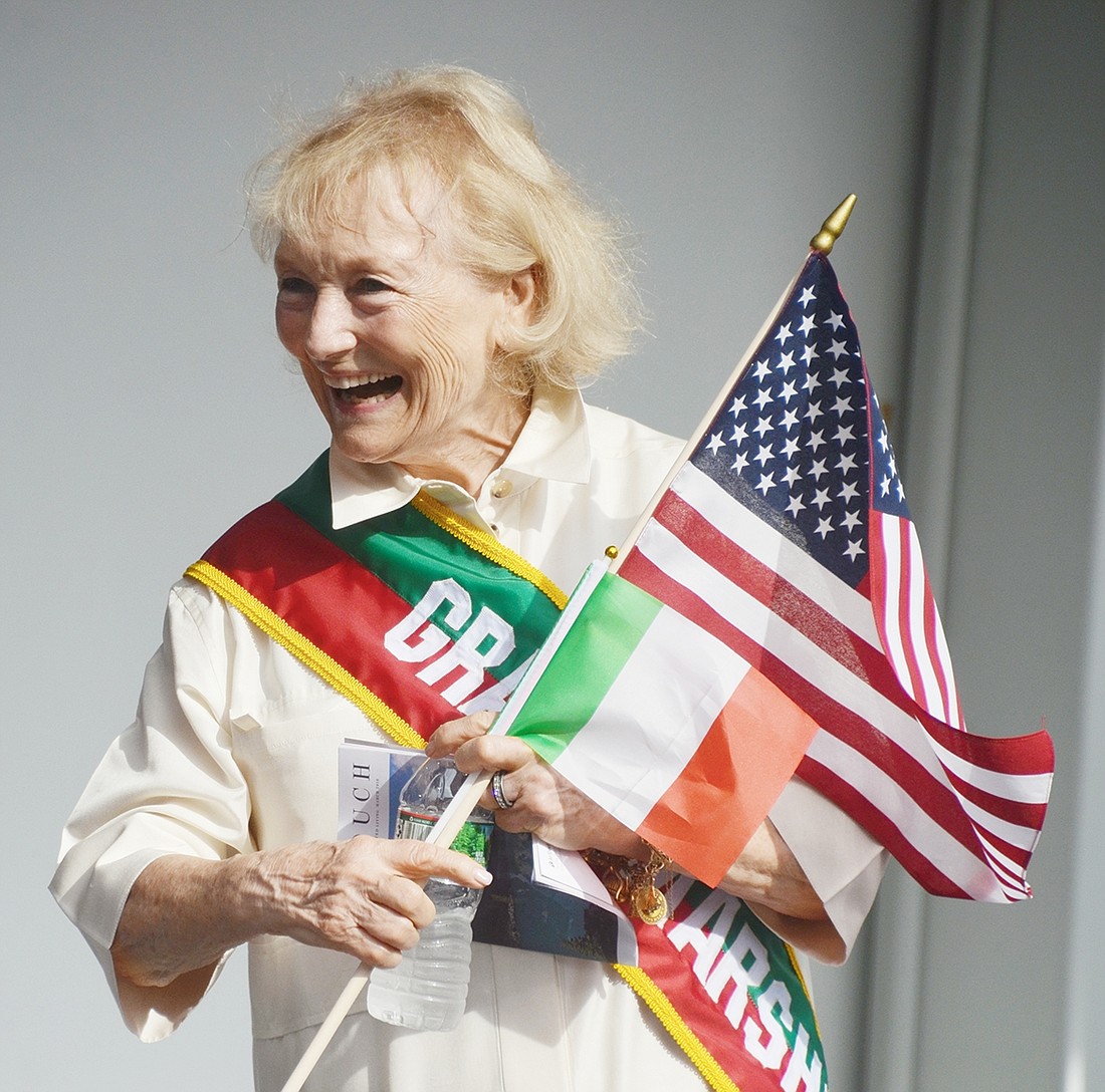 Anne Capeci, Port Chester’s beloved former school trustee and court clerk who died on July 4, laughs with friends and colleagues on the reviewing stand at the Columbus Day Parade in October 2018, the year she was honored as the procession’s grand marshal.