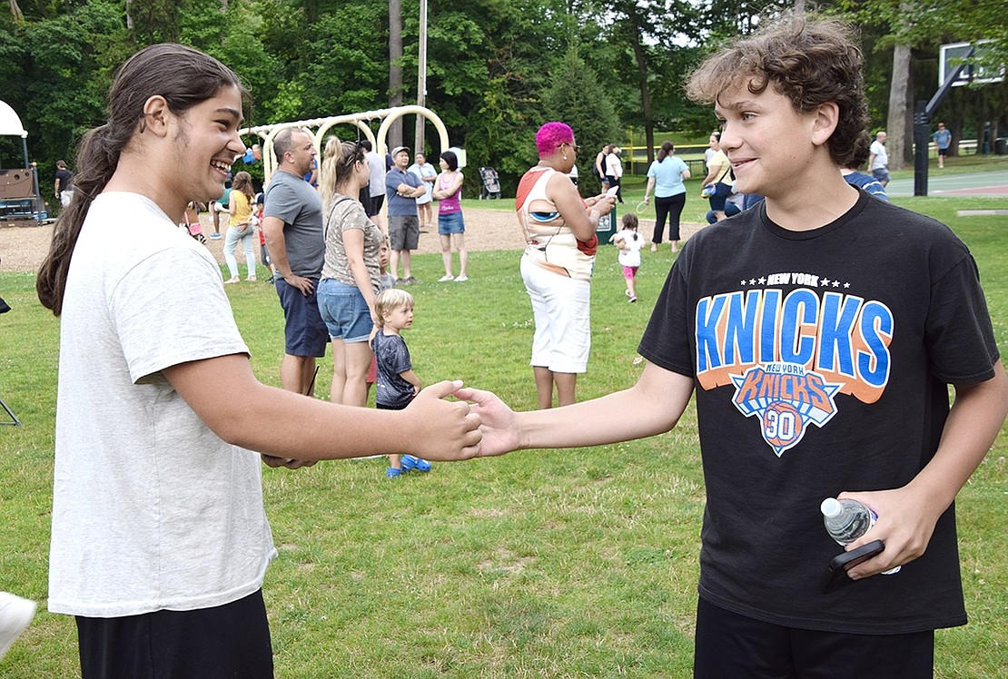 Blind Brook Middle School rising eighth-graders Jeffrey Mutis (left) and MJ Beatty shake hands and hang out at Pine Ridge Park.