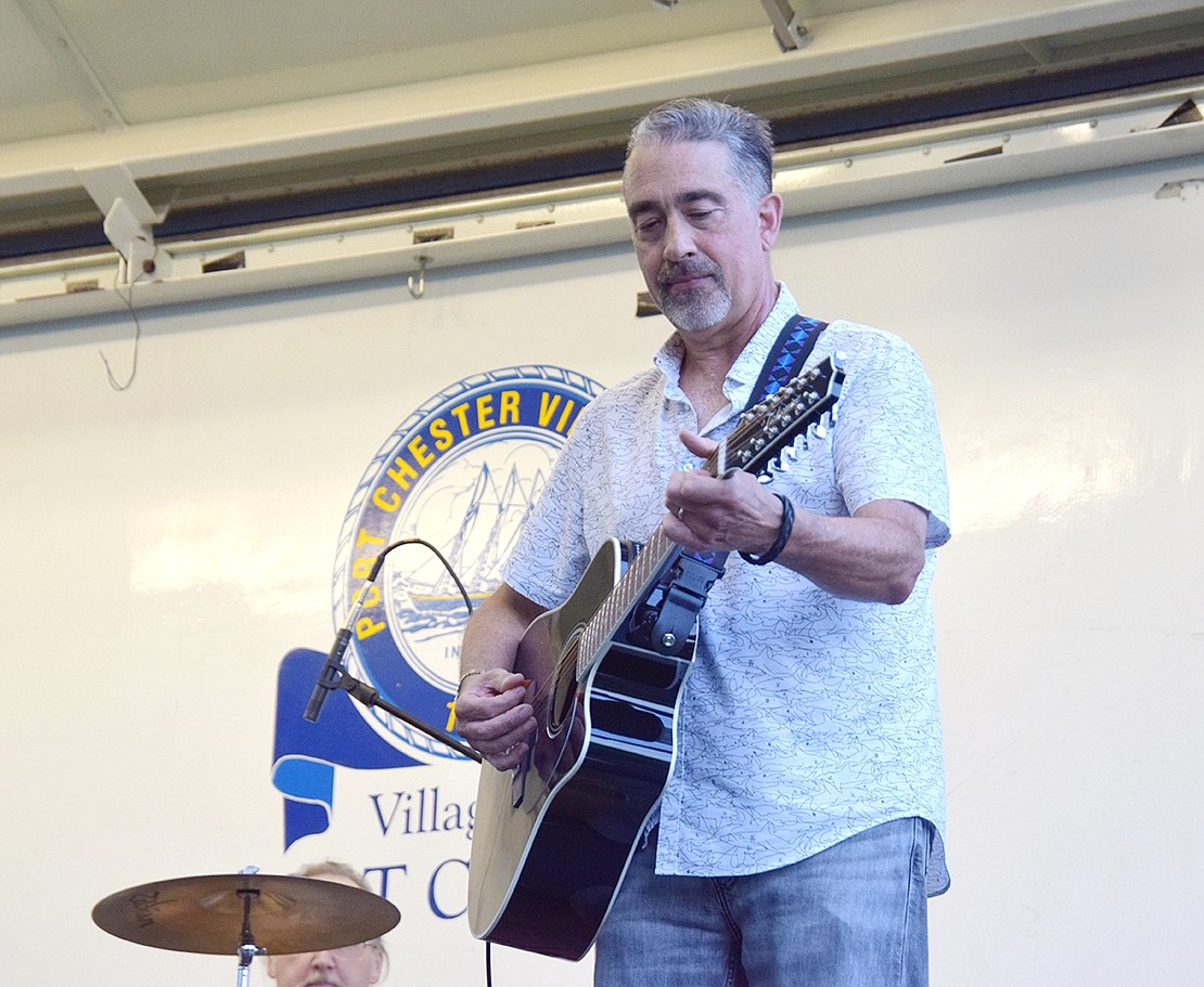 Mike Pinelli relaxes the mood with an acoustic guitar.