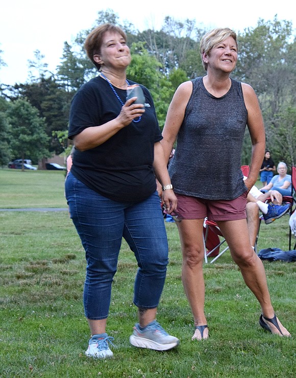 Best friends Phyllis Maguire (left), of Port Chester, and Utica resident Sue Culver dance at the Lyon Park concert. Maguire’s daughter, Kim Maguire, is a singer in Digging for Sharks.