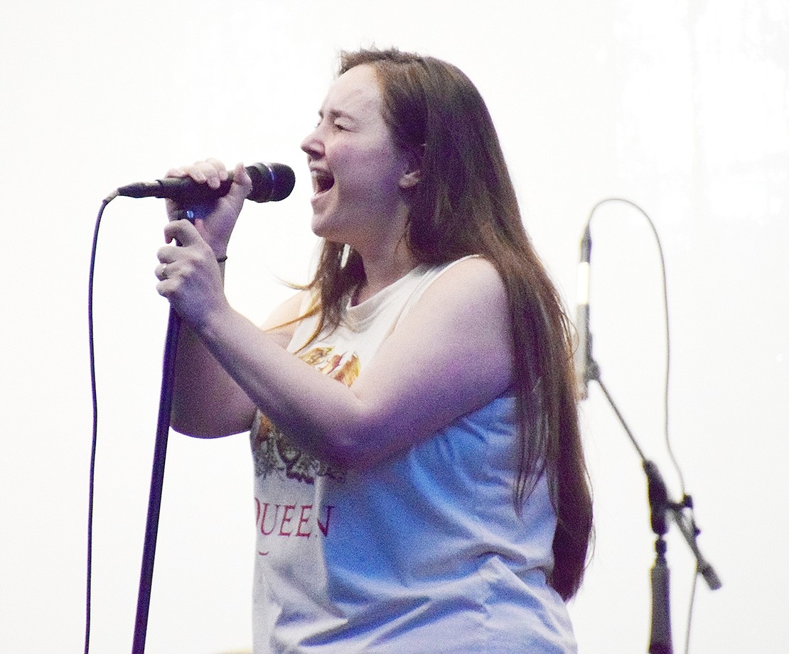 Singer Kim Maguire lets her voice loose during a cover of “Gimme Shelter” by The Rolling Stones.