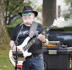 Ric LuBell is the bass player for the Armenian Rug Riders and smiles through the performance.