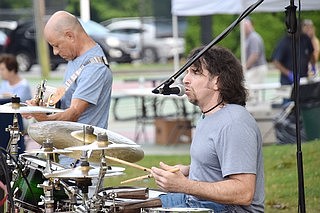 Brett Roberts (right) supplies backup vocals in addition to the rhythm and percussion for the band.