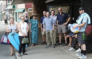 From left, County Legislator Catherine Parker, Rye Town Administrator Debbie Reisner, Rye Town Council Member Pamela Jaffee, County Legislator Nancy Barr, Rye Town Director of Grounds & Facilities Vic Federico, Rye City Mayor Josh Cohn, Rye Brook Mayor Jason Klein, Rye Town Supervisor Gary Zuckerman and Town Groundskeeper Matthew Garofalo wait for the free Bee-Line bus to Rye Town Park at the bus stop under the railroad bridge on Westchester Avenue in Port Chester.