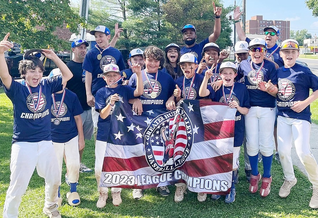 The Port Chester 12U Pirates celebrate after coming from behind to win their third and final game of the playoffs qualifying them as the 2023 Greater Hudson Valley Baseball League champions in their age group. Front row, from left: Brandon McConnell, Joey Szygiel, Tyler Hastings, JJ Dileo, Carter Chan, Ty Frimere, Joey Bologna, John Halliday. Back row, from left: Brian McConnell (coach), James Doherty, Evin Eski, Sophia Faraci, Terell Iconic (coach), Jonathan Smith, Jorge Herrera, Jim Doherty (coach).