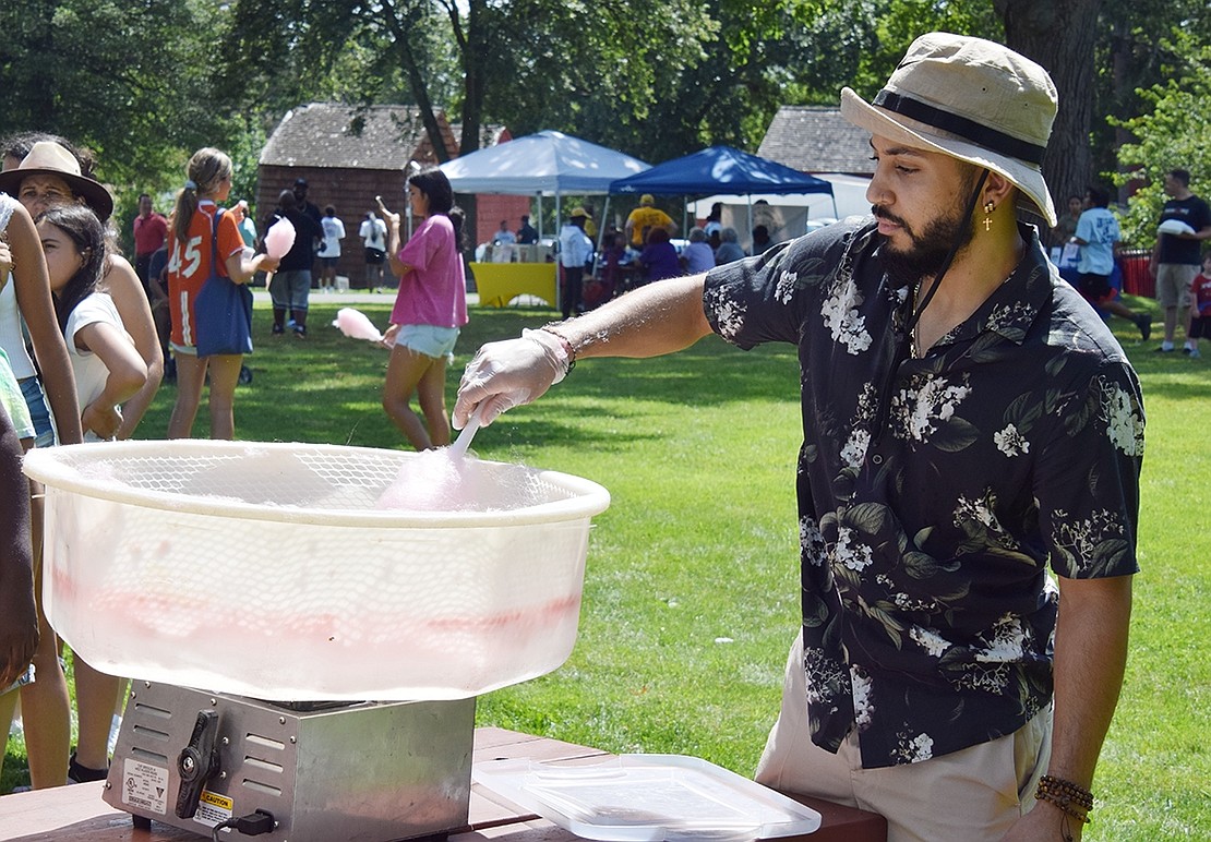 Dan Grullon of Darien, Conn. whips up some cotton candy for attendees of the Youth Summit.