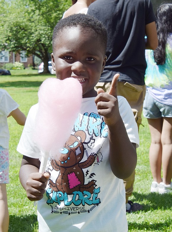 Four-year-old Messiah Smith, a Weber Drive resident, enjoys some cotton candy at the first annual Youth Summit held by the Port Chester Youth Bureau on Saturday, July 22, at Lyon Park. The summit, which featured music, a volleyball tournament, games and food, was open to youth bureaus from other municipalities as well.