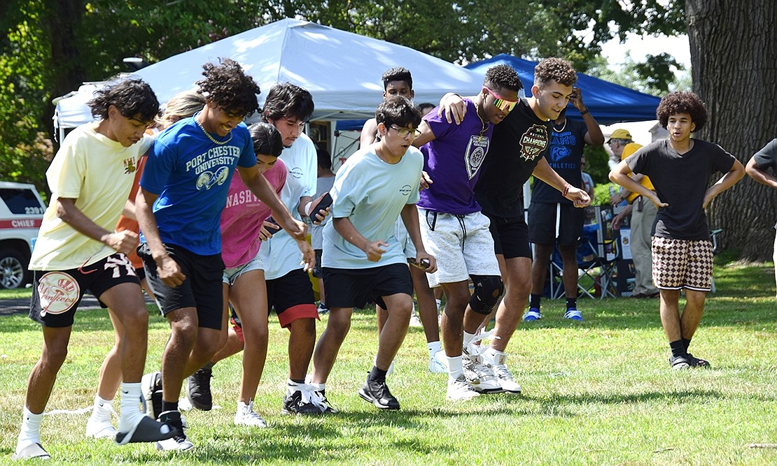 Attendees of the Youth Summit take off in a three-legged race.
