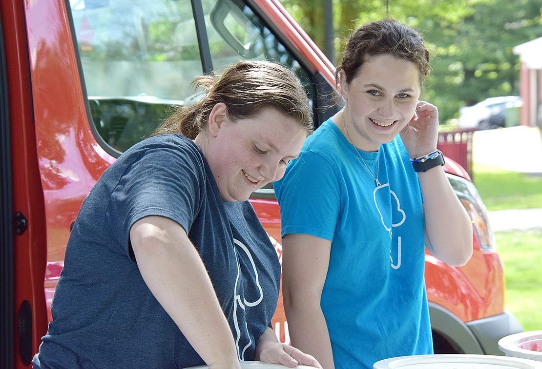 White Plains residents Megan Fay (left) and Amanda LeMark serve ice cream at the Youth Summit.