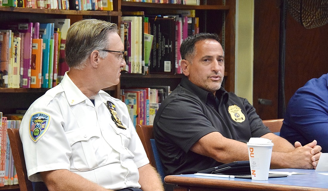 Rye Brook Police Chief Greg Austin looks toward Police Sergeant Luigi Greco as he discusses how Student Resource Officers would be integrated into the Port Chester School District during a community discussion on Monday, July 31.