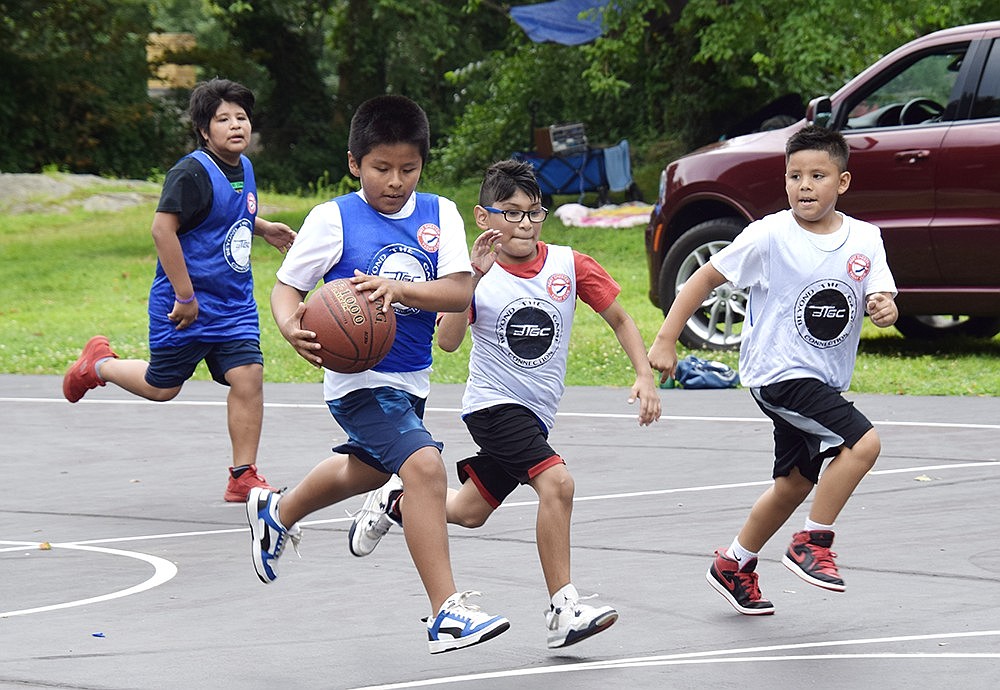 Elementary school-aged basketball players from Port Chester compete against one another in the tournament held during Unity Day, an annual event celebrating the summer that also serves as a reunion for current and former Village residents, at Columbus Park on Saturday, Aug. 12. In addition to the tournament, food and vendors were at the event.