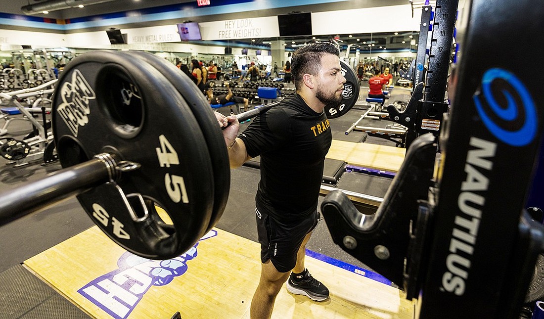 Lizandro Espinosa lifts weights at Crunch Fitness in Port Chester. The former Port Chester High School star athlete is now the fitness manager there and is one of the guiding spirits behind its new Division 1 Athletics 1-on-1 sports training program.