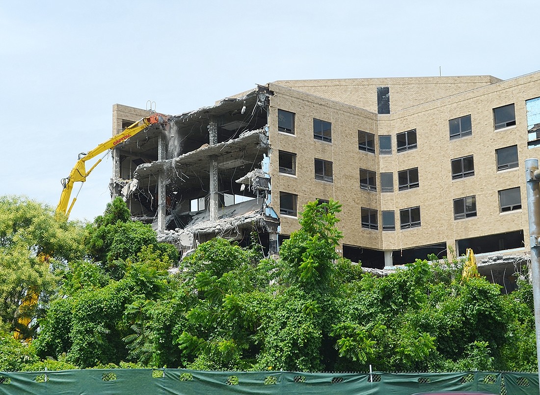 The long arm of a demolition excavator slowly eats away at the first portion of the multi-winged hospital building on the former United Hospital site at 406 Boston Post Rd. in a controlled demolition on Monday, Aug. 14.