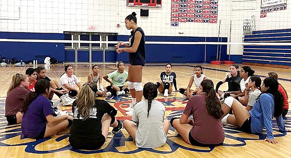 Blind Brook varsity volleyball players listen attentively to former Division 1 volleyball player Alisa Mejia who is a Quinnipiac University volleyball alumna during a clinic at Blind Brook High School on Aug. 18.