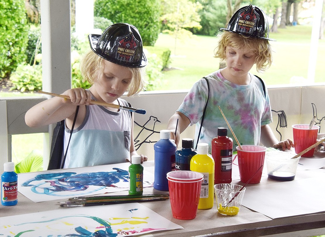 Keeping cool under the gazebo, Huey, 6, and Jack, 9, Zlabinger of Hawley Avenue put their artistic talents to paper with painting materials supplied by the Nowodworski Foundation.