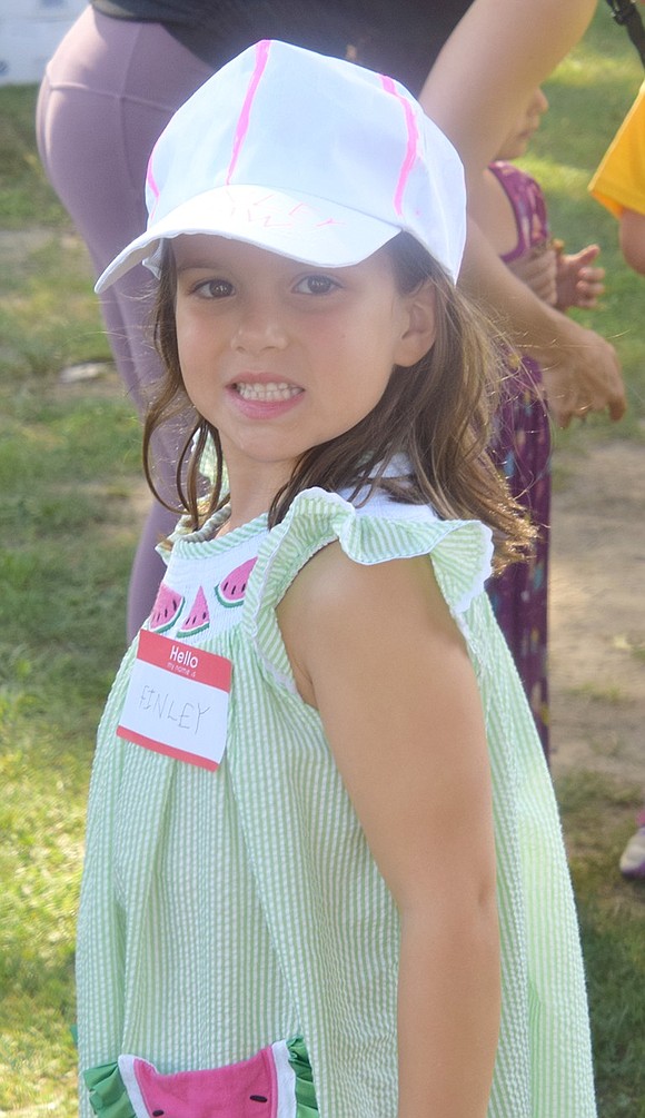 Future fashionista of Blind Brook Finley Shaw poses for a photo, modeling the hat she suavely decorated at the arts and crafts station.