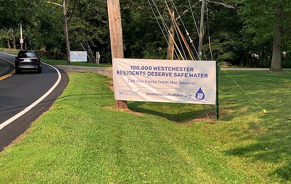 The Westchester Joint Water Works (WJWW) posted this banner sign on Anderson Hill Road at the Harrison/Rye Brook border urging water users in both communities to demand clean, filtered water and the construction of the court-mandated filtration plant.