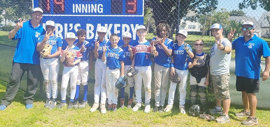 The Port Chester Youth Baseball League 12U Pirates give the victory sign after winning the second game of a doubleheader Sunday (9/3) at Lyon Park by a score of 14-3. They are, from left, Coach Steve Rytelewski, Aaron Malhotra, Wesley Loizeaux, Fabio Garcia, Alex Malhotra, Louis Rytelewski, Juan Garcia, Ross Kantor, Maikel Herrera, Braden Squillace, Tyler Varbero, Coach George Varbero, Coach Fabio Garcia.