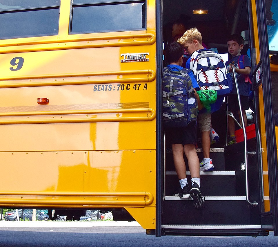 Ridge Street Elementary School students make their climb onto the bus, marking the start of their journey home after the first day of the 2023-24 school year.