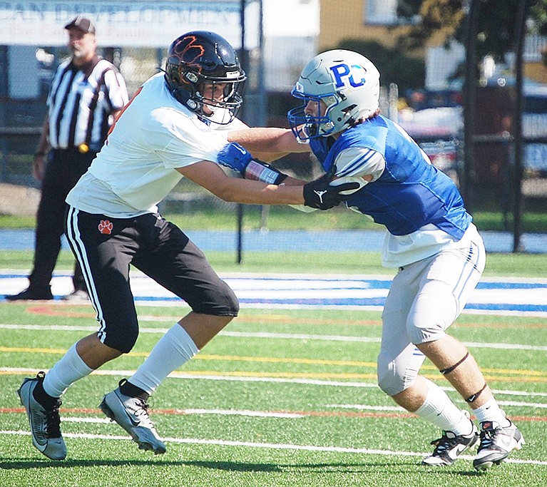 Junior Scott Sullivan (right) tangles with a Tuckahoe player during the third quarter of the Port Chester Rams’ season-opening home loss to the Tigers last Saturday (9/2). Sullivan was one of the Rams’ better defensive players throughout the game.