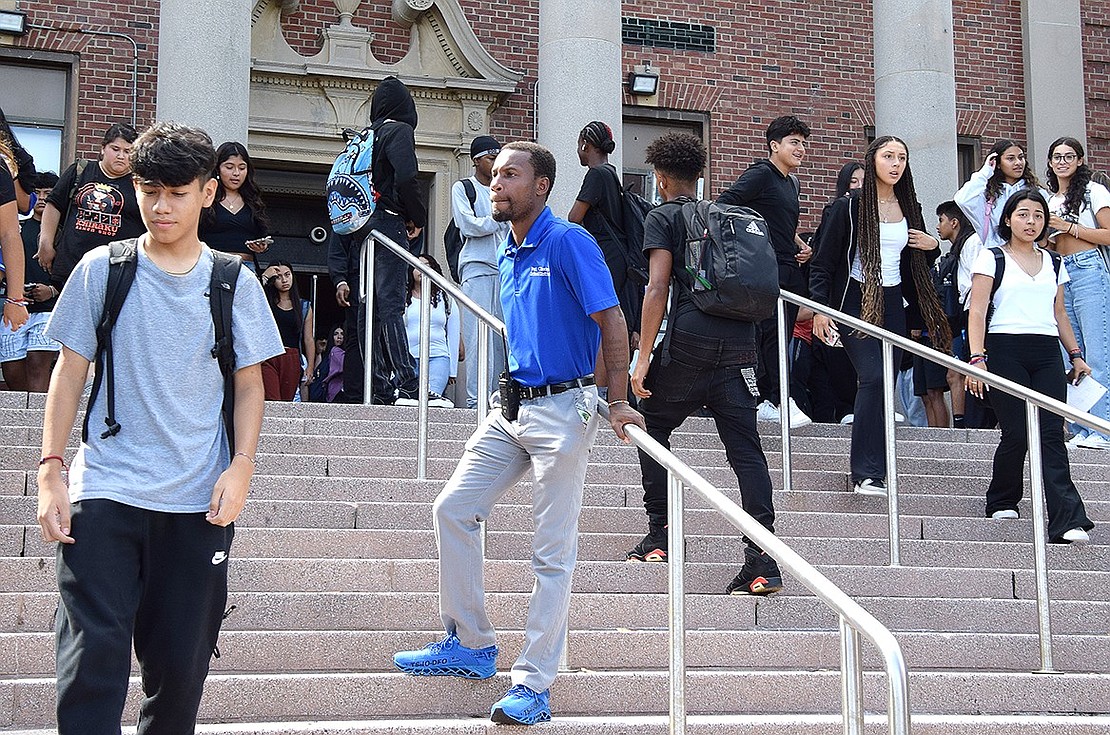 Port Chester High School hall monitor Aaron Pettiford (center) makes sure that students leave school in a safe and orderly manner after the third day of classes on Monday, Sept. 11.