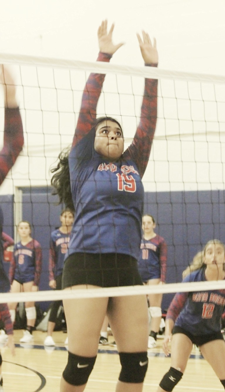 Tanisha Venkatapur leaps through the air, blocking the volleyball and earning her team a point in Blind Brook’s Thursday, Sept. 7 home opener, which resulted in a victory for the Lady Trojans.