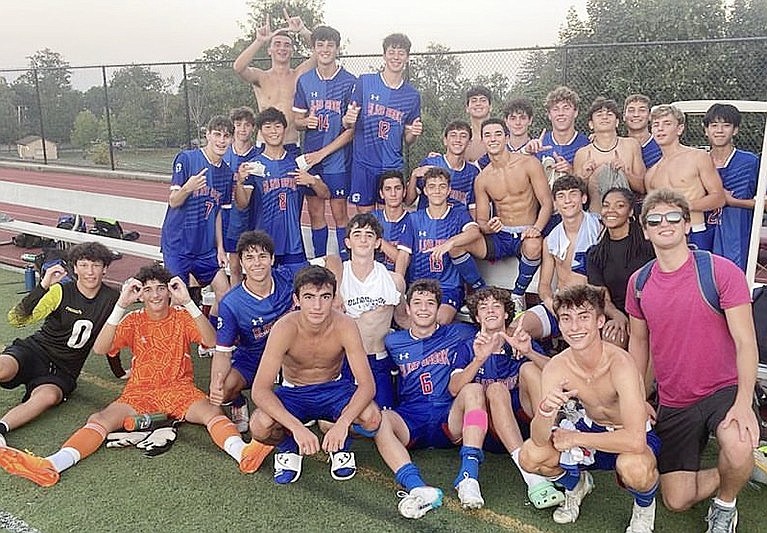 A jubilant Blind Brook boys’ varsity soccer team poses after their first game victory at home on Wednesday, Sept. 6. The Trojans shut out the Putnam Valley Tigers 3-0.