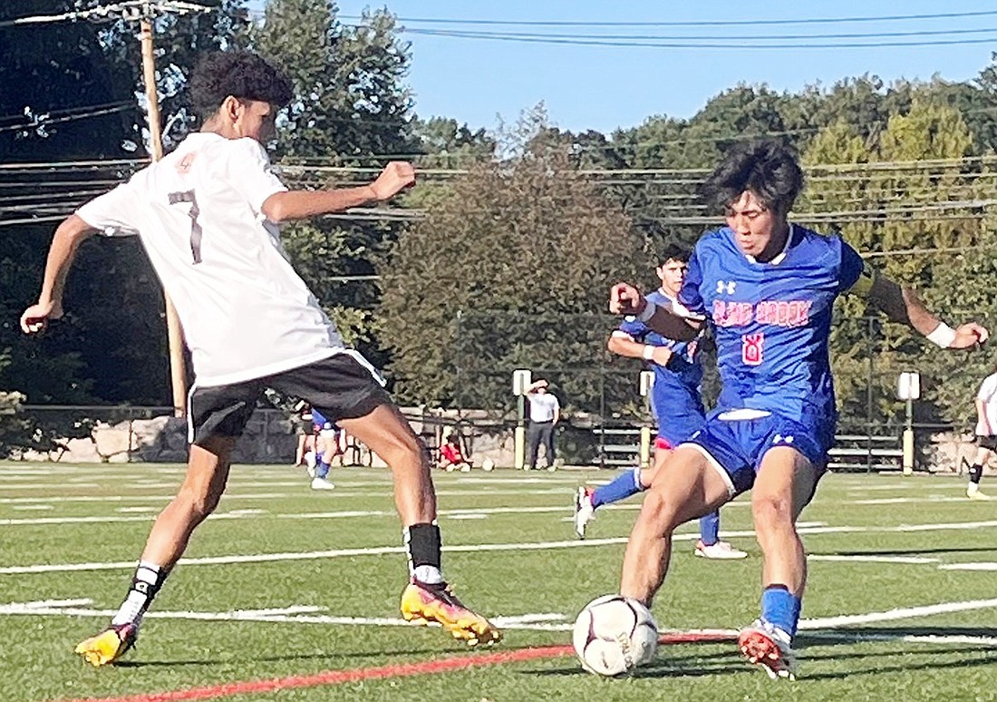 Captain Tomo Yamano battles for possession of the ball against a Croton-Harmon opponent in Blind Brook’s home game on Thursday, Sept. 14. The Trojans defeated the Tigers 3-2 in overtime.