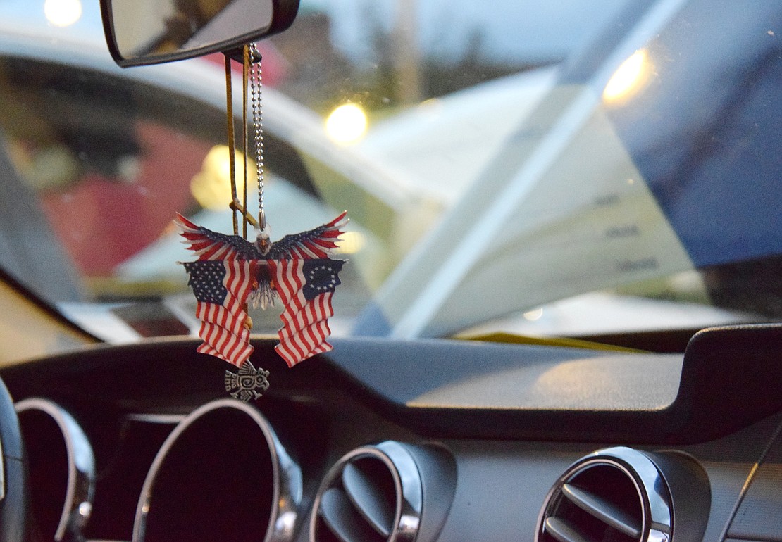 An American flag hangs on the rearview mirror of a 2005 Mustang GT on display.