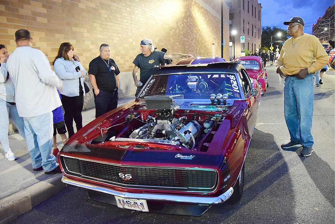 John Zicca, a local landscaper, shows off his 1967 Chevrolet Camaro SS to one of the many crowds that visited him during the Port Chester Fire Department’s Classic Car Show on Friday, Sept. 22. Hundreds of people made their way to Abendroth Avenue that evening to check out the cars, trucks and fire vehicles from a wide range of years on display in celebration of the department’s 200th anniversary.