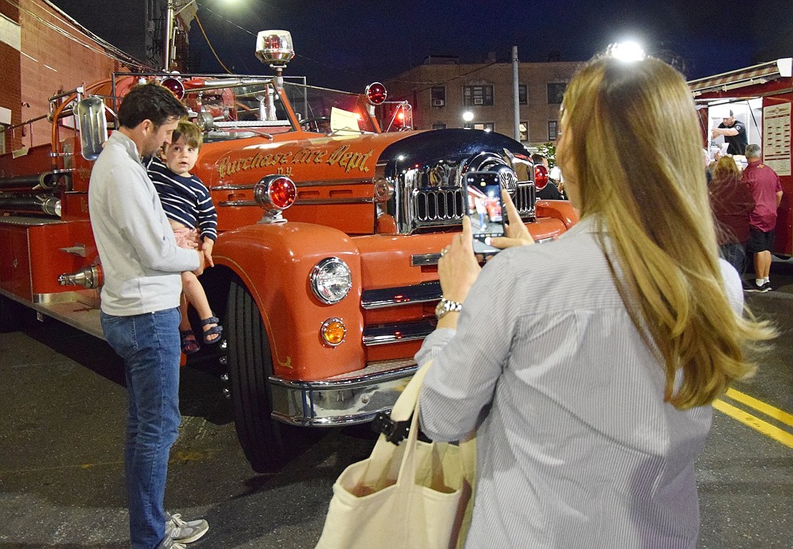 Greenwich, Conn. resident Kaitlyn Delaney snaps a photo of her husband and son, Luke and Mac, next to a vintage Purchase Fire Department truck.