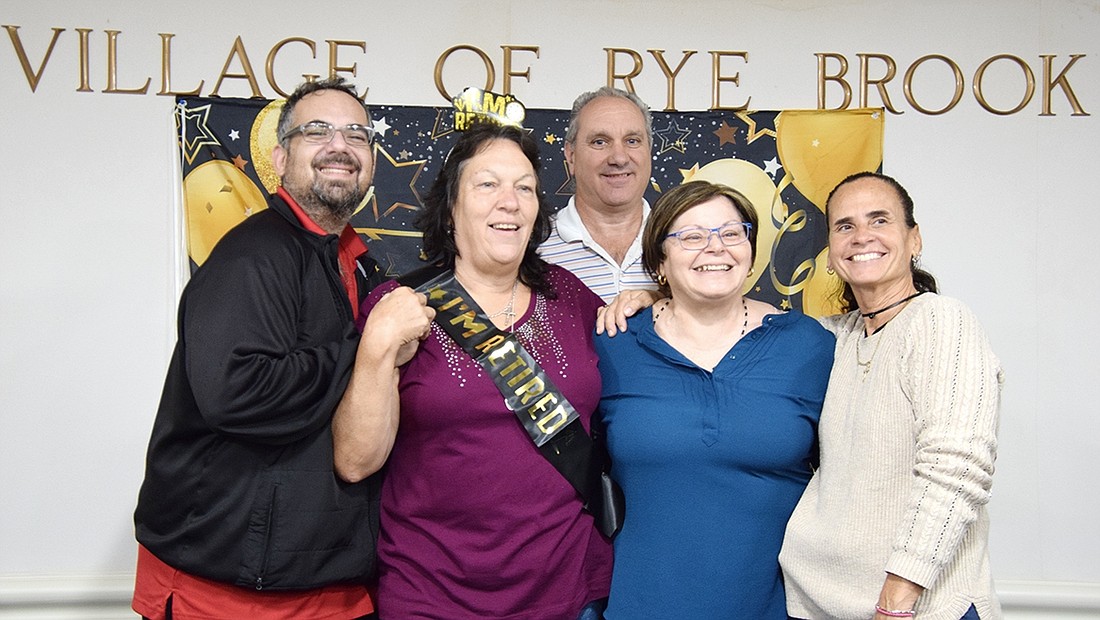 The Rye Brook Recreation Department will now be minus a key person, Senior Recreation Leader Janice Kunicki, wearing the “I’m Retired” sash. Other department members pose with her at her retirement lunch at Village Hall on Tuesday, Sept. 26. They are, from left, Recreation Assistant Rocco Furano, Parks and Recreation Superintendent Robert “Bert” Bertolacci, Senior Office Assistant Rose D’Ascoli and Recreation Supervisor Kathy Laoutaris.