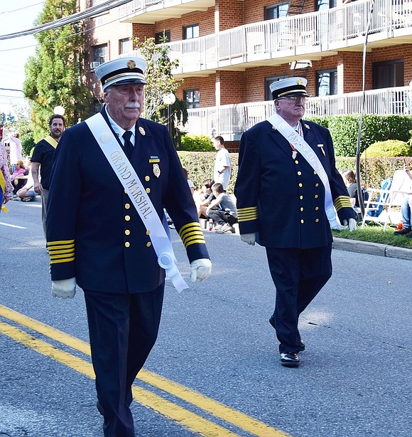 Parade Grand Marshal Vinny Lyons (left), the oldest living deputy chief of the Port Chester Fire Department, marches alongside the 200th Anniversary Co-Chairman Thomas Gallagher.