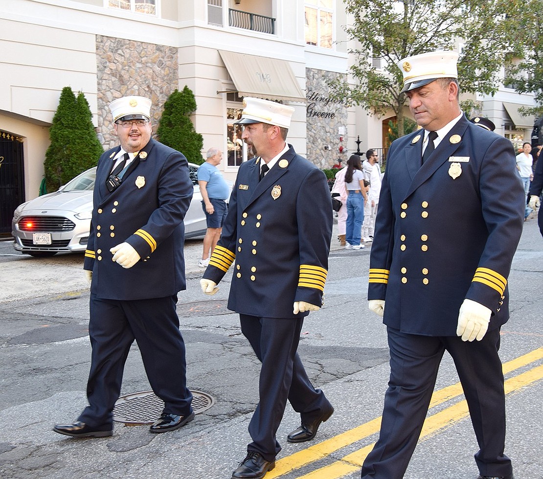 Port Chester Fire Department 2nd Assistant Chief Engineer Nicholas Melillo (left), Chief Engineer Angelo Sposta and 1st Assistant Chief Engineer John Storino walk ahead of their fellow firefighters.