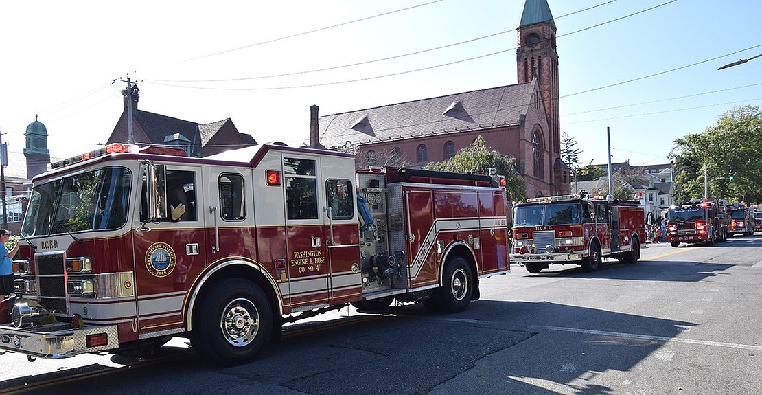 Port Chester Fire Department trucks make their way towards the marina, honking their horns in celebration as they pass spectators.
