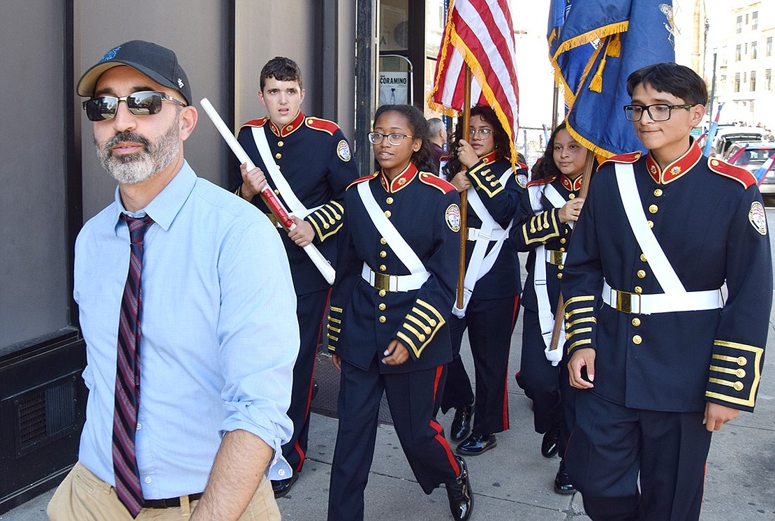 The Pride of Port Chester band director Mike Miceli leads his musicians back to the start of the parade after a successful performance along the route.
