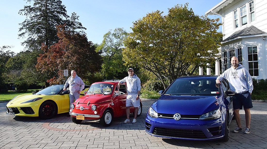 Rye Brook residents Peter Goldstein (left), Al Lucca and Michael O’Neill pose on Monday, Oct. 2 with their 2023 Chevrolet Corvette, 1967 Fiat 500, and 2015 Volkswagen Golf R, respectively, at Crawford Park.