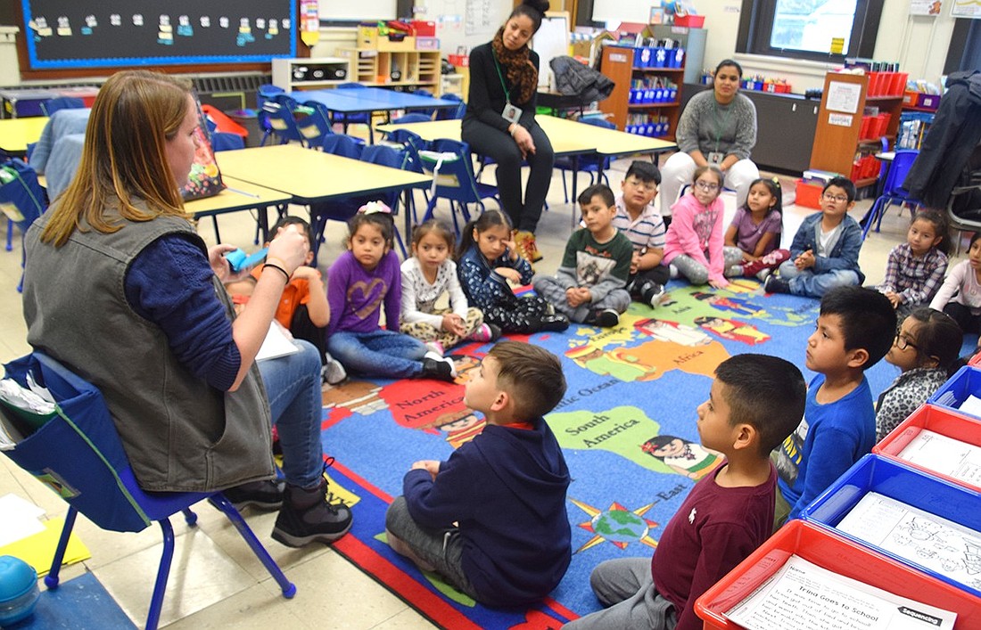 Students attending the Edison Elementary School afterschool program operated by the Carver Center listen attentively to a lesson about nature in 2020. That year, 124 students from the school were enrolled in the program. This year, that number has dropped to 34.