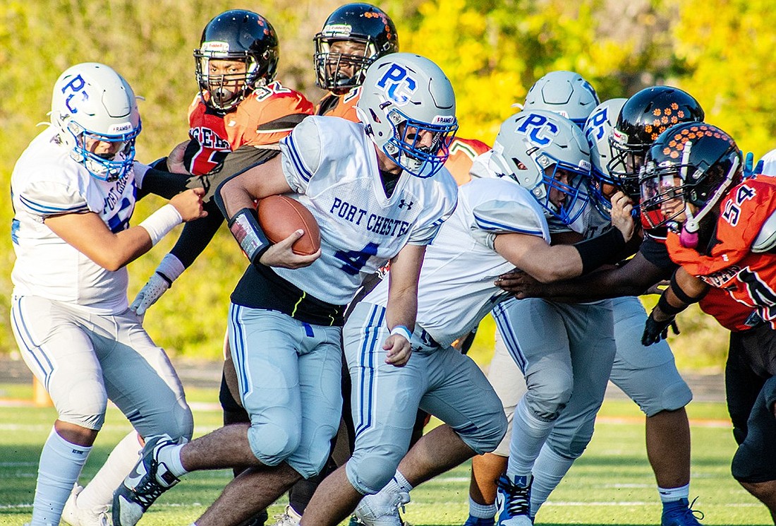 Port Chester High School fullback John Pauletti (4) runs with the ball to make the first down during the Rams’ Monday, Oct. 2 away game against Spring Valley. The Tigers defeated the Rams 38-0.