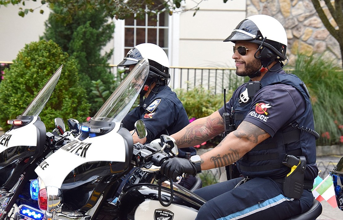 A smile emerges from Port Chester Police Officer David Arroyo’s face as he leads a brigade of motorcycles down Westchester Avenue.