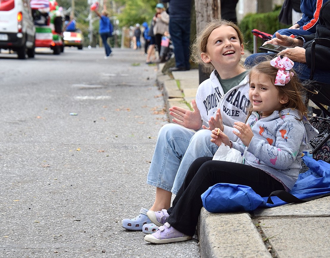 A little nervous about the blaring sounds, Port Chester 3-year-old Piper Telesca claps to the music while accepting comfort through the companionship of her 9-year-old cousin, Caroline Sullivan of New Milford, Conn.
