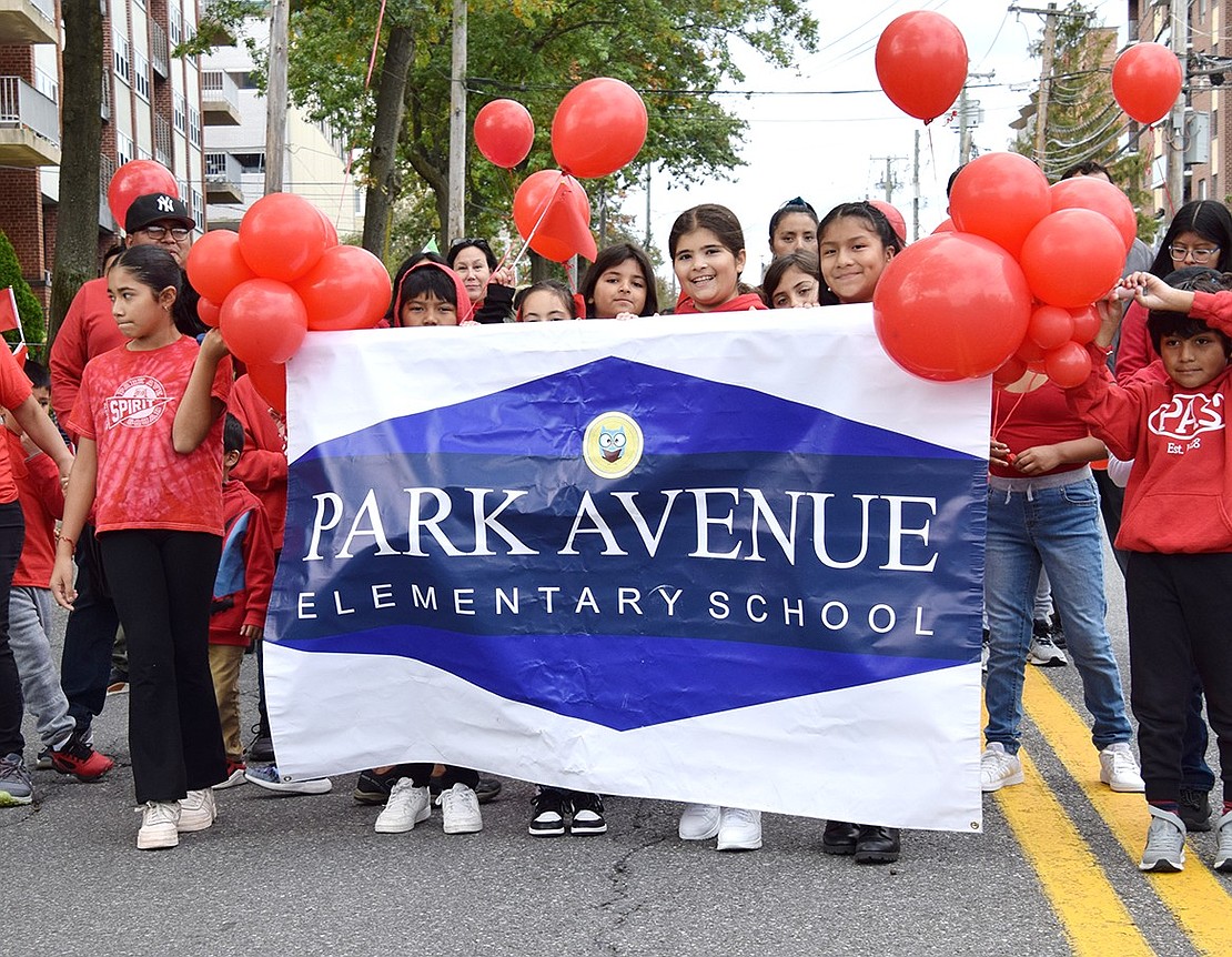 Park Avenue Elementary School students proudly smile for the camera as they sport their school’s color and pose by the banner.