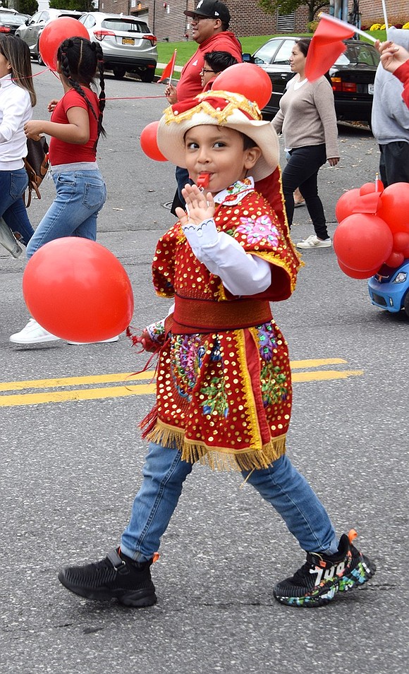 Park Avenue Elementary School students could be heard across the avenue as each pupil, such as kindergartner Joel Coronel, holds a bright red whistle to march with.