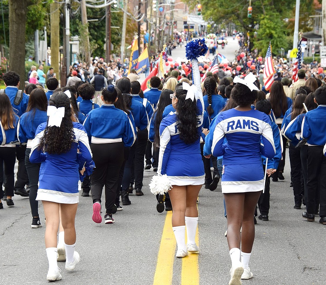 With pep in their step, Port Chester Middle School cheerleaders follow their school’s band, raising spirit as they strut down the hill.