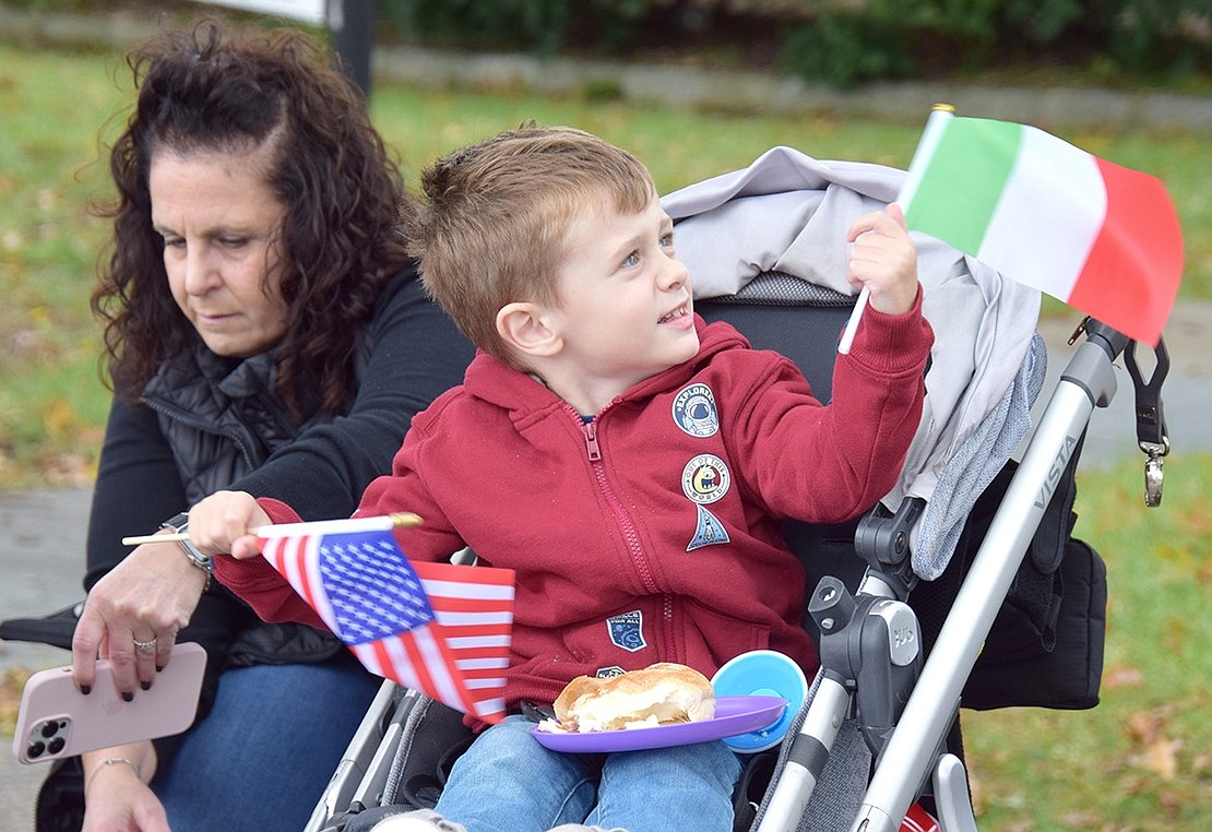 Harrison resident Peter Pergamo, a 3-year-old visiting his family in Port Chester, uses his American and Italian flags to dance to the music.