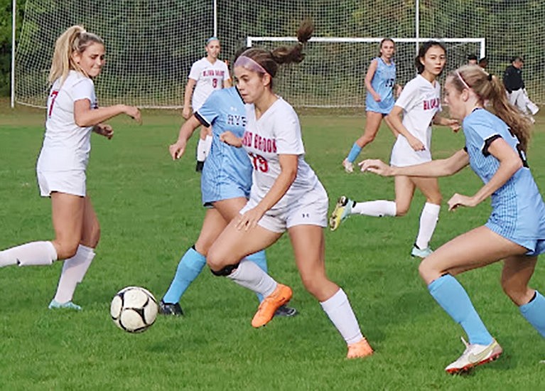 Alex Maniscalco strategically moves around her opponents to clear the ball away from them in Blind Brook’s 3-2 away victory over Rye Neck on Tuesday, Oct. 10.