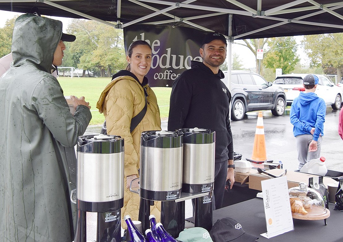 Volunteer barista Christiana Spinola (left) and owner of the Port Chester-based café The Producer Coffee Studio Noah Mrnacaj are all smiles as they offer warm drinks to attendees of the event.