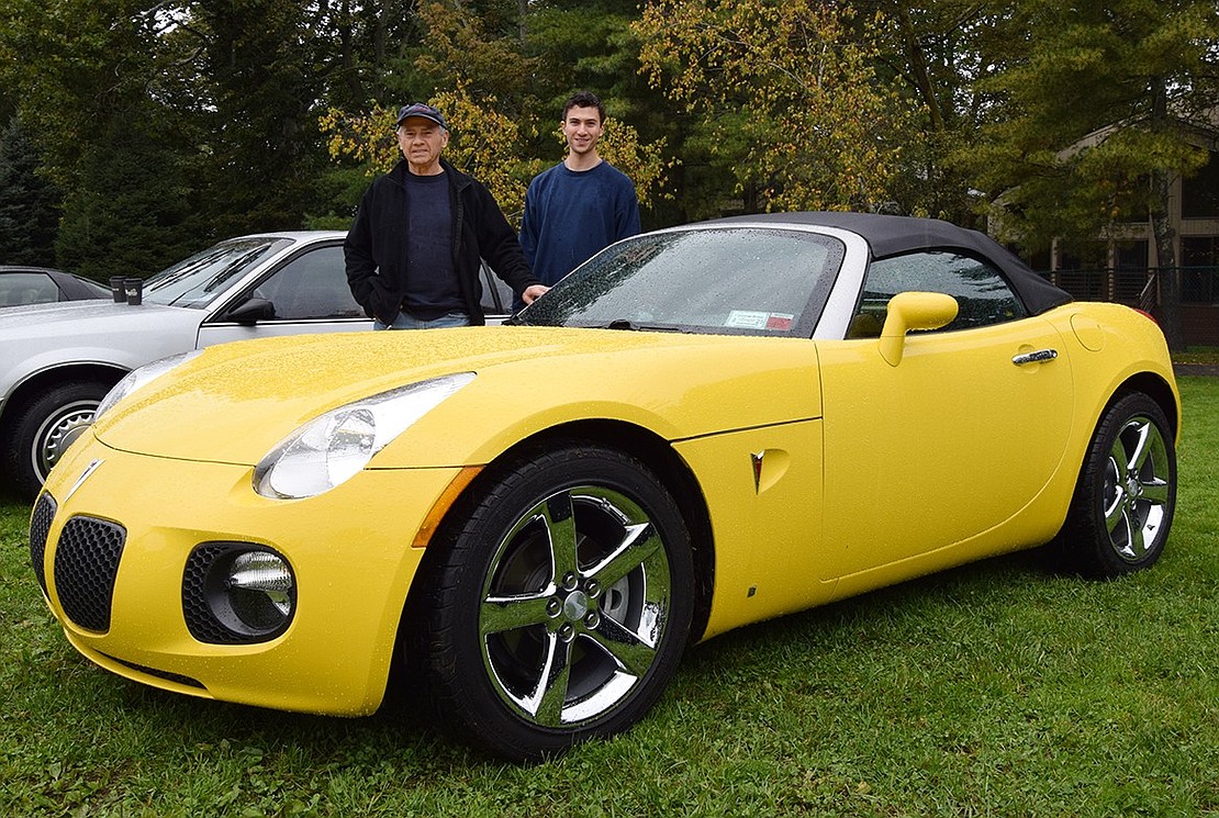In spite of the rain, the inaugural Cars & Coffee exhibit took place on Saturday, Oct. 14, at Crawford Park. While there, Port Chester residents Cliff Hodge and his son Jason, a Port Chester High School Class of 2018 graduate, proudly show off a 2006 Pontiac Solstice.