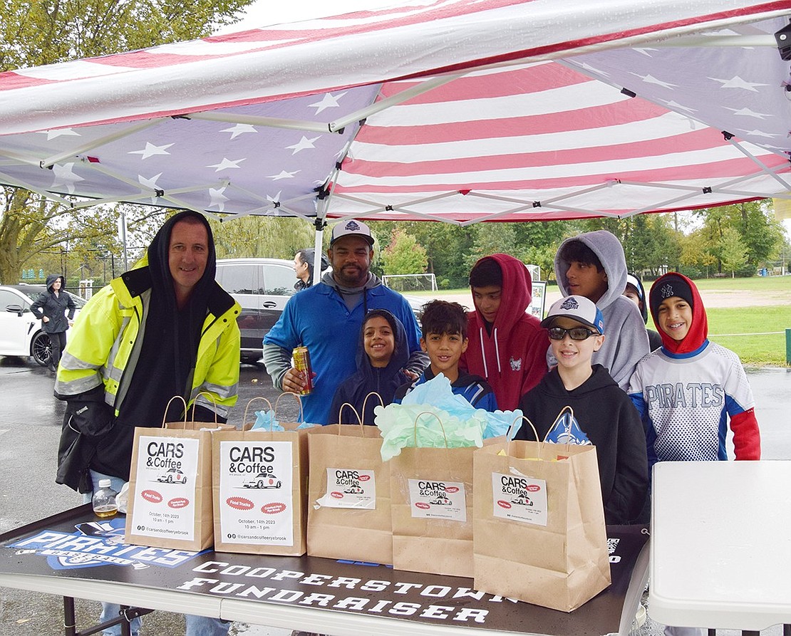 Coach Stephen Rytelewski and members of the Port Chester Pirates 12U travel baseball team set up a table to raise money for the squad to attend a tournament in Cooperstown next summer.
