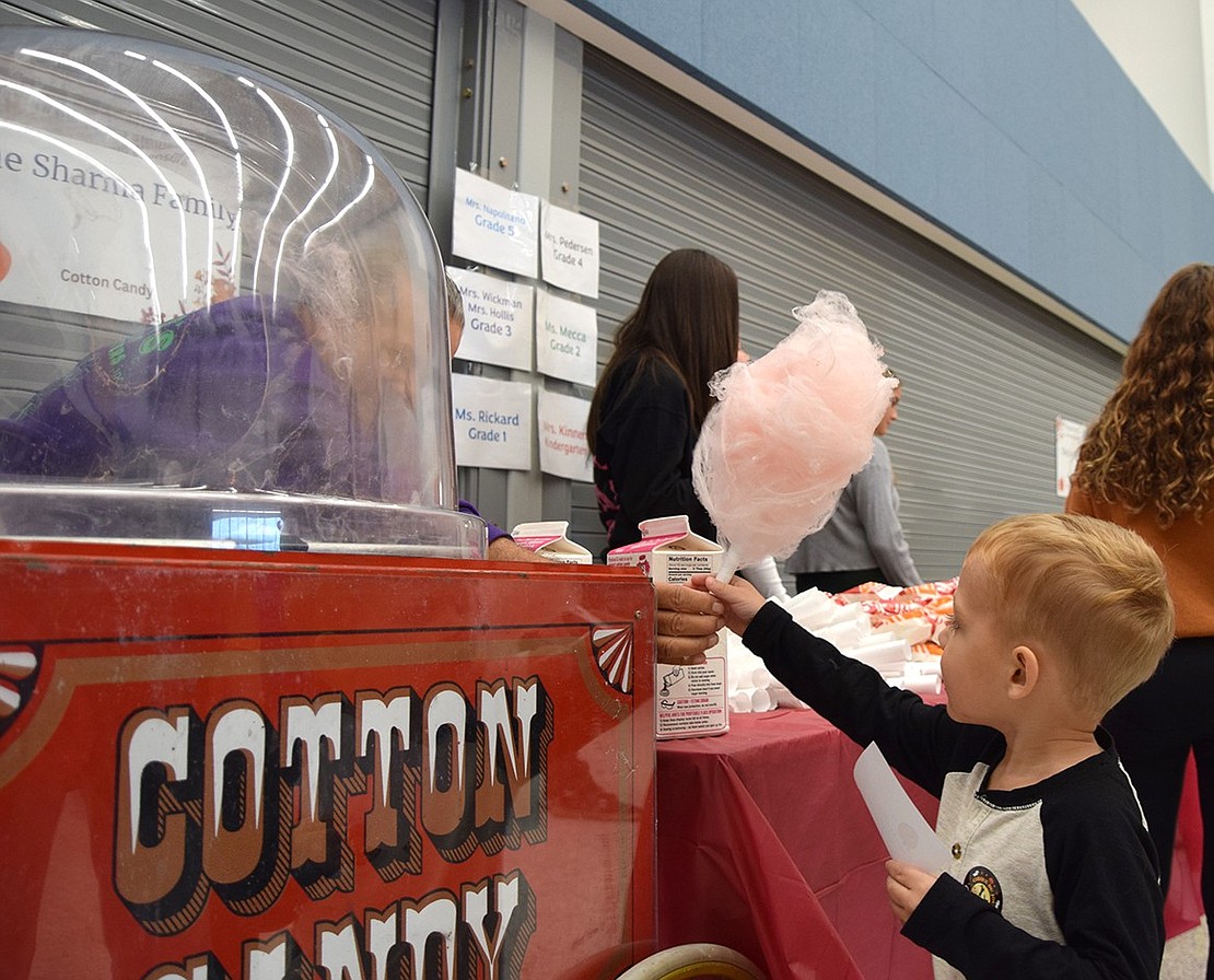 In need of a sugary pick-me-up, Rye Brook resident Robert Gagnon, 3, grabs a stick of cotton candy.